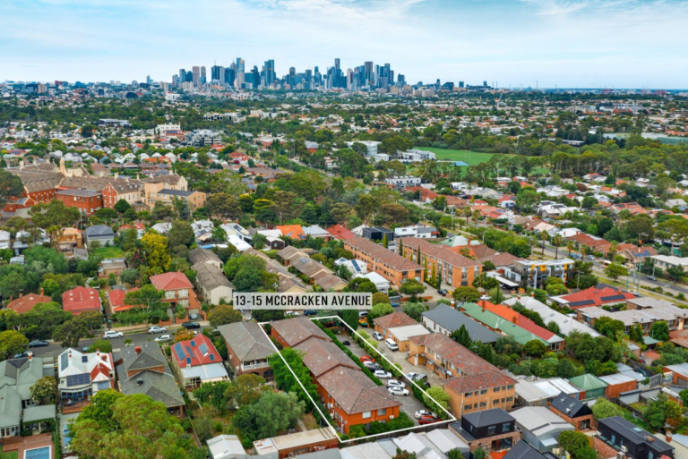 a drone photo of a block of apartments in Northcote with the skyline of the Melbourne CBD in the background.